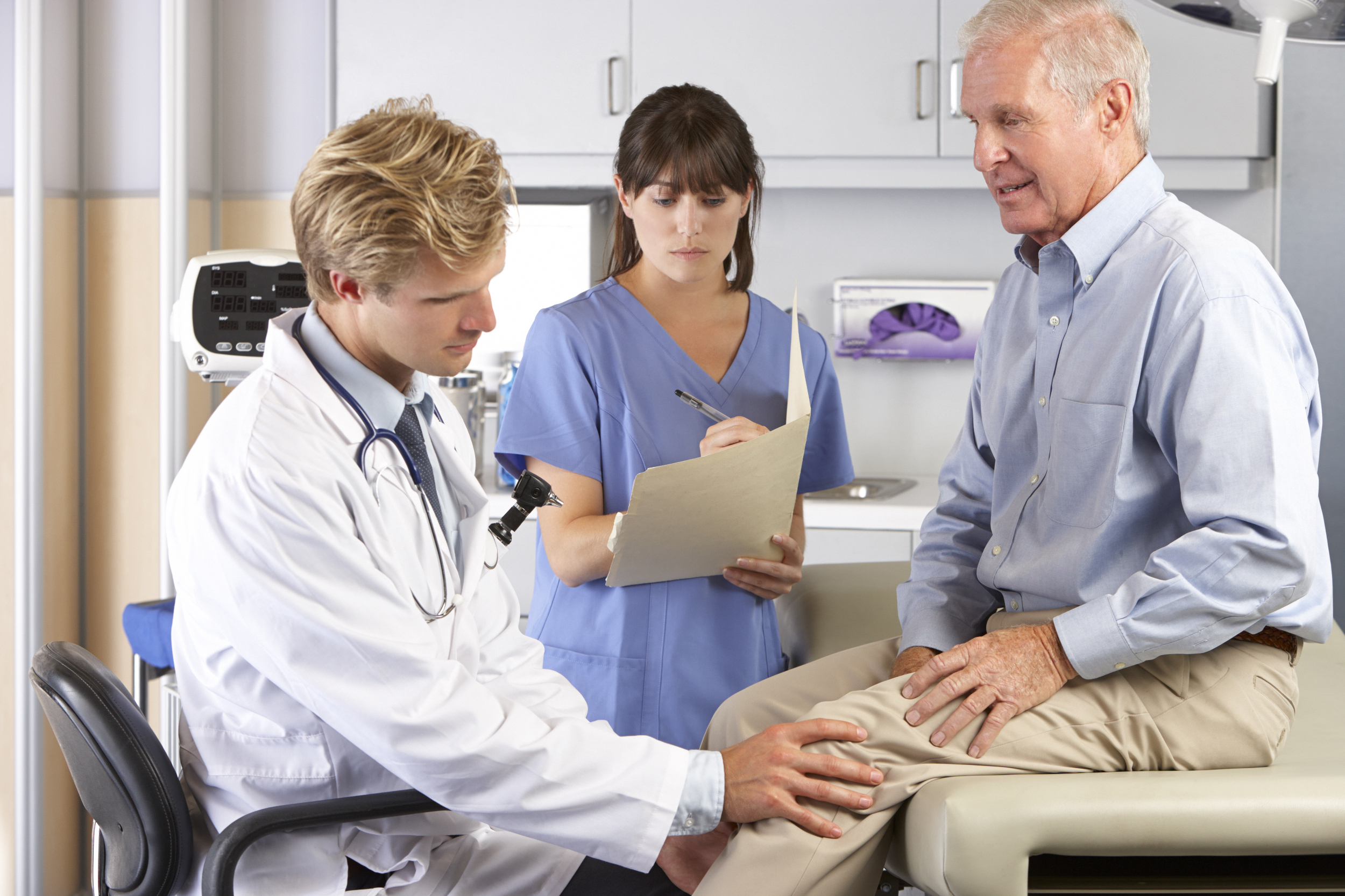 doctor-examining-elderly-mans-knee